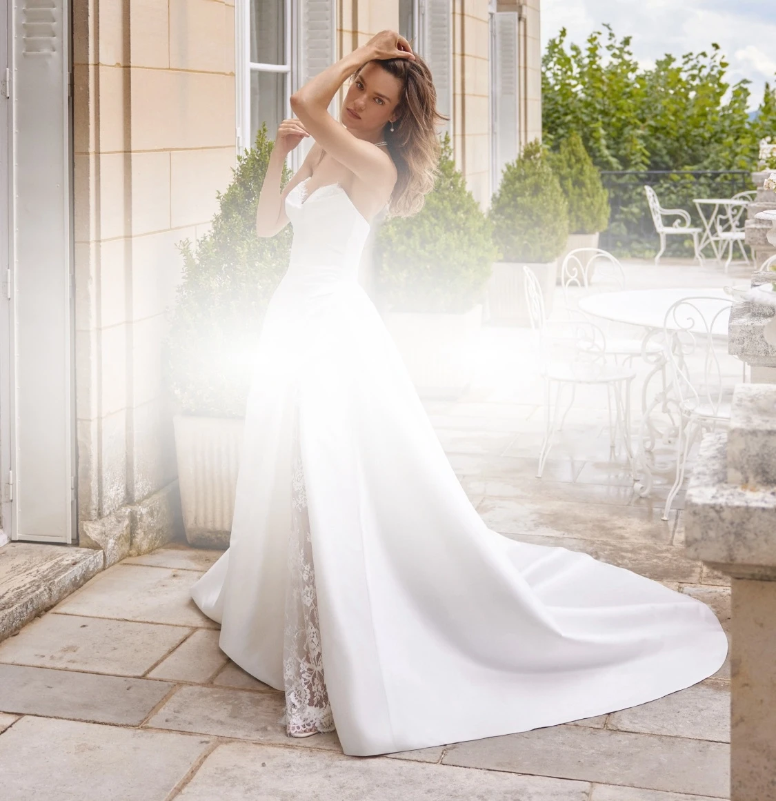 Model wearing a white gown. Mobile image