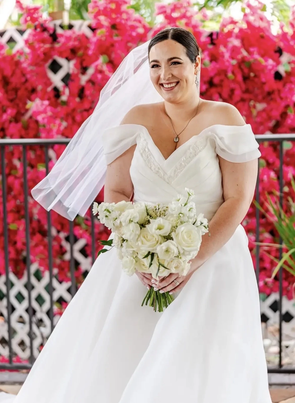 Сouple wearing a white gown and a white suit