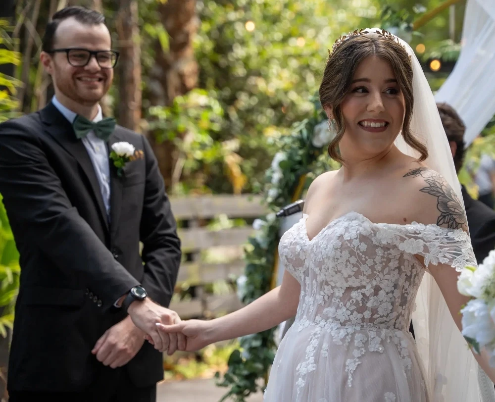 Сouple wearing a white gown and a gray suit