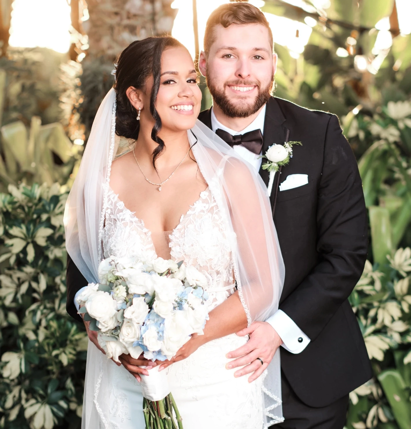 Сouple wearing a white gown and a black suit