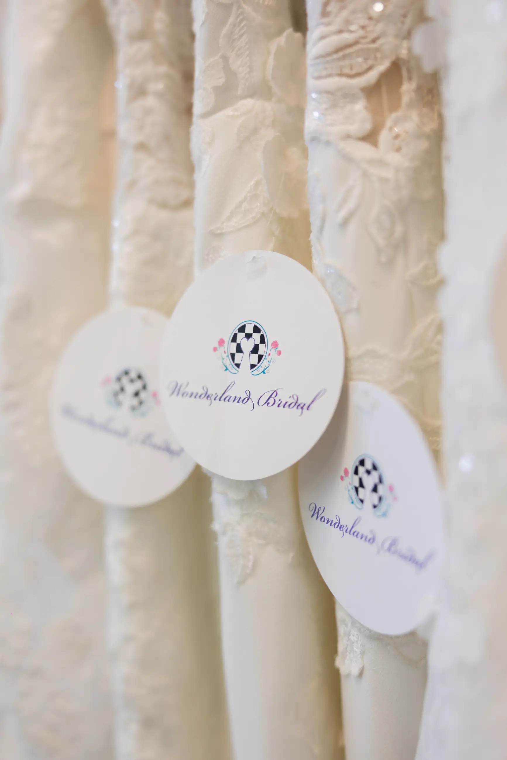 Lace wedding dresses labeled with Wonderland Bridal tags
