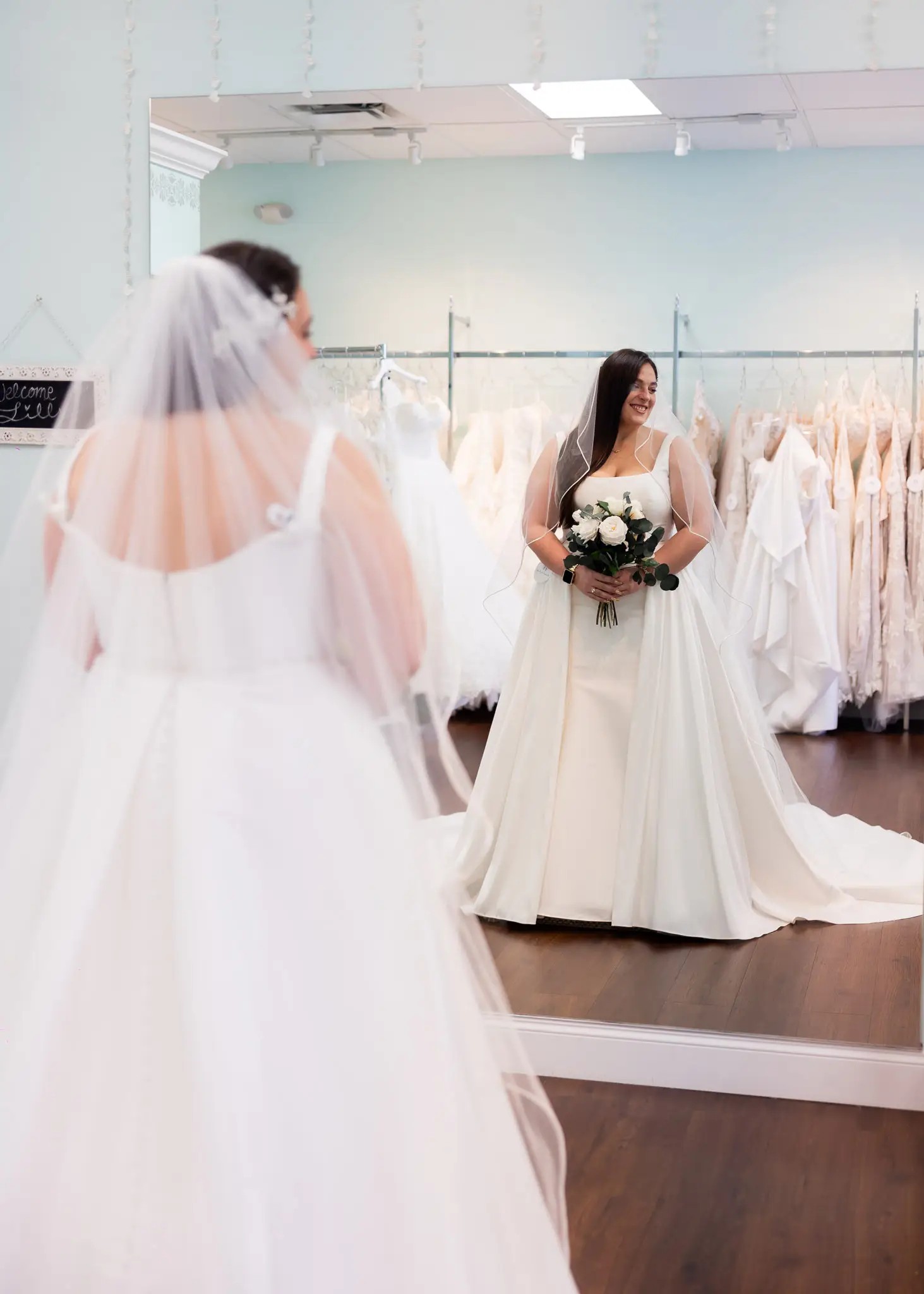 Bride wearing ivory bridal gown with a veil.